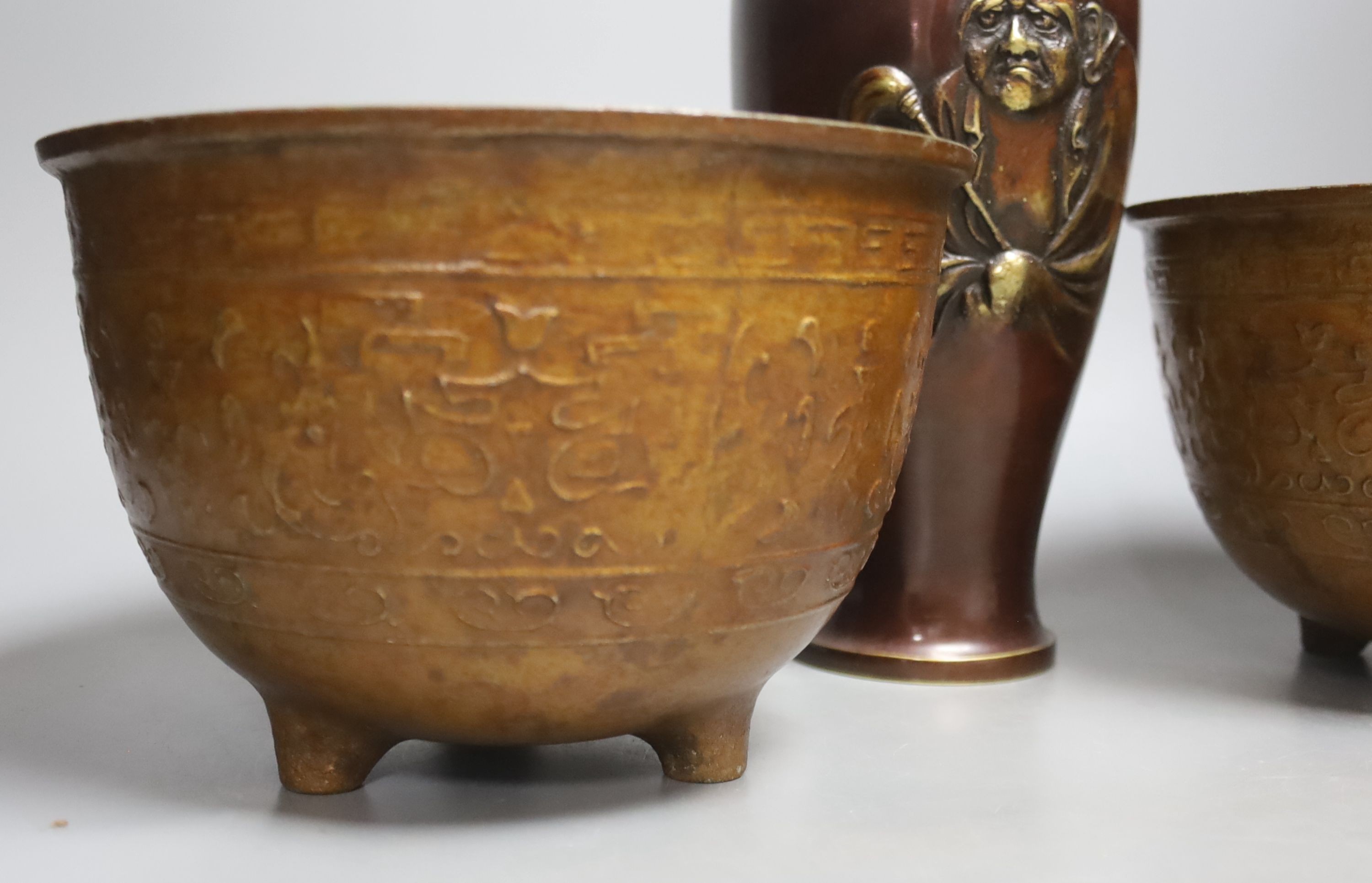 A Japanese bronze 'Daruma' vase and a pair of bronzed aluminium tripod bowls, vase 25 cms high.